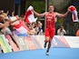 England's Alistair Brownlee runs towards the finish line to claim gold in the mixed relay on July 26, 2014