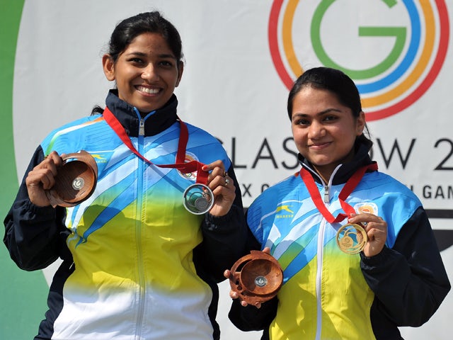 Gold medalist Apurvi Chandela and Silver medalist Ayonika Paul both of India pose for pictures with their medals following the Women's 10m Air Rifle at the Barry Buddon Shooting Centre in Carnoustie, Scotland, on July 26, 2014