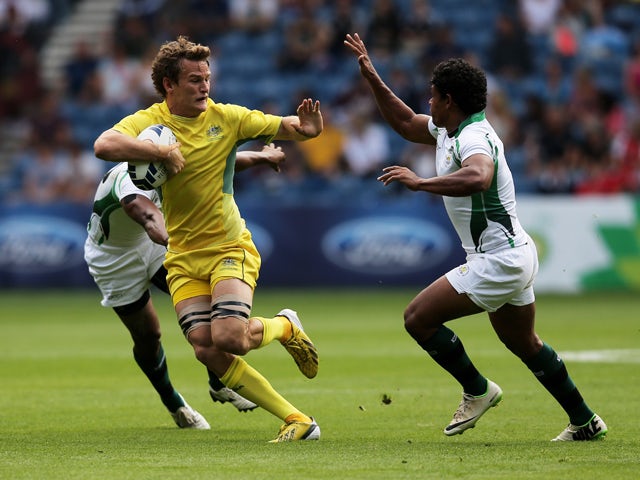 Con Foley of Australia is tackled by Sudharshana Muthutantri of Sri Lanka in the Rugby Sevens match between Australia and Sri Lanka at Ibrox Stadium during day three of the Glasgow 2014 Commonwealth Games on July 26, 2014