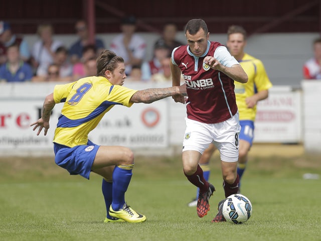 Dean Marney of Burnley competes with Josh Windass of Accrington during the pre-season friendly between Accrington Stanley and Burnley at the Store First Stadium on July 27, 2014
