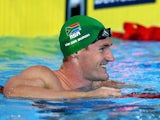 South Africa's Cameron van der Burgh celebrates setting a new games record during the 50m breaststroke semi-final on July 27, 2014