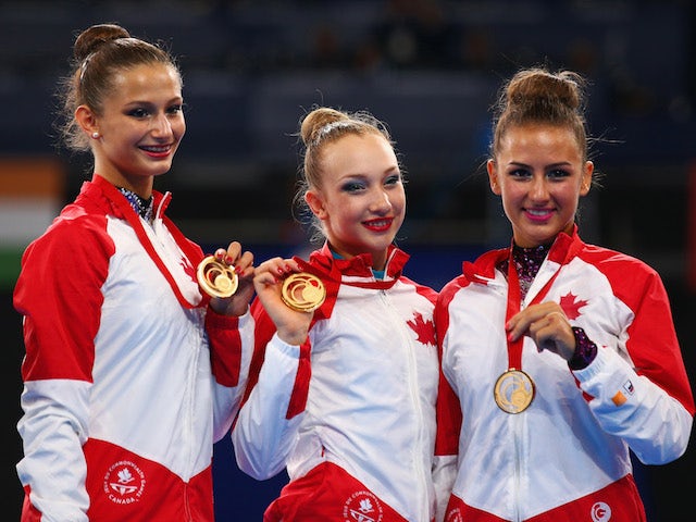 Gold medalists Annabelle Kovacs, Patricia Bezzoubenko and Maria Kitkarska of Canada pose on the podium after winning the rhythmic gymnastics Team event at the Glasgow Commonwealth Games on July 24, 2014