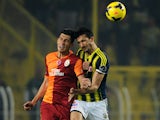 Fenerbahce's Mehmet Topal fights for the ball with Galatasaray's Ceyhun Gulselam (L) during the Turkish Super League football match between Fenerbahce and Galatasaray, at Sukru Saracoglu stadium in Istanbul, on November 10, 2013
