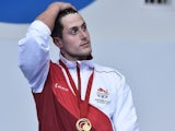 A decidedly broody Chris Walker-Hebborn on the podium after winning gold for England in the men's 100m backstroke on July 25, 2014