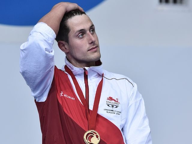 A decidedly broody Chris Walker-Hebborn on the podium after winning gold for England in the men's 100m backstroke on July 25, 2014