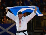 Scotland's gold medalist Christopher Sherrington poses with the Scottish flag at the medal ceremony for the men's judo +100kg class at the SECC Precinct during the 2014 Commonwealth Games in Glasgow, Scotland on July 26, 2014
