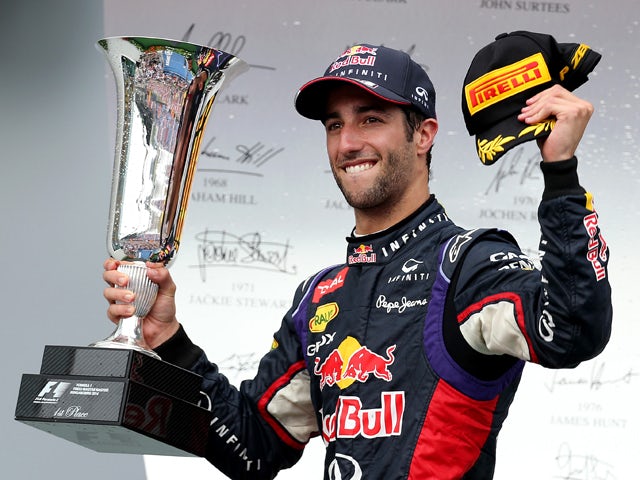 Daniel Ricciardo of Australia and Infiniti Red Bull Racing celebrates victory with the trophy on the podium after the Hungarian Formula One Grand Prix at Hungaroring on July 27, 2014