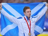 Daniel Wallace holds the Scottish flag proudly after taking gold in the 400m individual medley on July 25, 2014