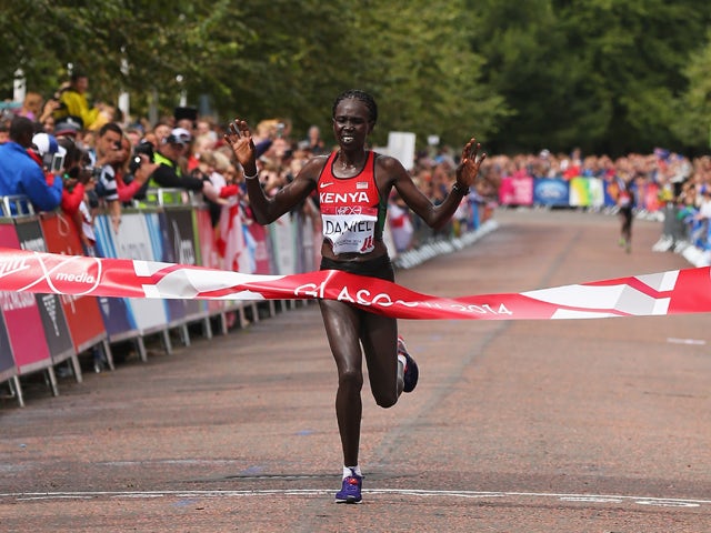 Flomena Cheyech Daniel of Kenya crosses the line to win gold in the Women's Marathon on the city marathon course during day four of the Glasgow 2014 Commonwealth Games on July 27, 2014