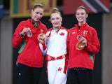 Gold Medalist Patricia Bezzoubenko of Canada (C), Silver Medalist Francesca Jones of Wales (L), and Bronze Medalist Laura Halford of Wales (R) pose with their medals after the individual all-around rhythmic gymnastics event at the Commonwealth Games on Ju