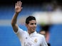 James Rodriguez waves to fans during his unveiling as a new Real Madrid player at the Santaigo Bernabeu stadium on July 22, 2014