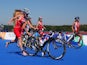 Jodie Stimpson transitioning between cycling and running on her way to Team England's first gold in the women's triathlon on July 24, 2014