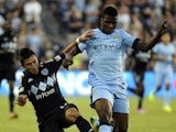 Sporting Kansas City midfielder Mikey Lopez battles with Manchester City FC forward Kelechi Iheanacho during an exhibition match at Sporting Park July 23, 2014 