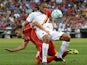 Liverpool's Fabio Borini tussles with Roma's Seydou Keita during a friendly soccer match between Liverpool and Roma at Fenway Park, July 23, 2014