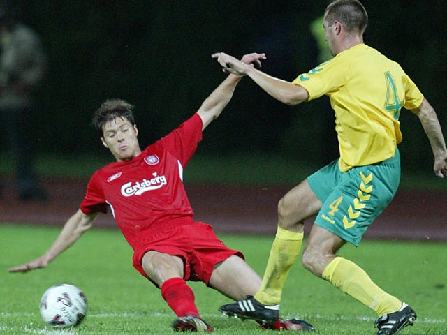 FBK Kaunas player Mindaugas Pacevicius vies with Liverpool FC player Xabi Alonso at Darius ir Girenas stadium 26 July 2005