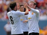 Wayne Rooney #10 of Manchester United celebrates his second goal with Juan Mata #8 during the first half of an International Champions Cup match against AS Roma at Sports Authority Field at Mile High on July 26, 2014