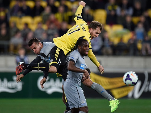 Newcastle United's Steven Taylor and Rolando Aarons jump for the ball with Phoenix's Jeremy Brockie during the Phoenix and Newcastle United football match at the Westpac Stadium in Wellington on July 26, 2014