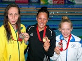 Gold medallist Sophie Pascoe of New Zealand poses with silver medallist Madeleine Scott of Australia and bronze medallist Erraid Davies of Scotland after the medal ceremony for the Women's 100m Breaststroke SB9 Final at Tollcross International Swimming Ce
