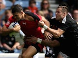 New Zealand's Tim Mikkelson hauls down Justin Douglas of Canada in the Rugby 7s on July 26, 2014