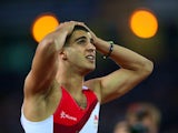 Adam Gemili holds his hands on his head after finishing second in the men's 100m on July 28, 2014