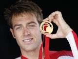 England's Alex Dowsett poses with his gold medal during the Men's Cycling Individual Time Trial medal ceremony at the 2014 Commonwealth Games in Glasgow, Scotland on July 31, 2014