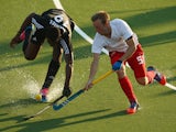 Shaquille Daniel of Trinidad and Tobago and Barry Middleton of England compete for the ball during the Men's preliminary match between England and Trinidad and Tobago at Glasgow National Hockey Centre during day one of the Glasgow 2014 Commonwealth Games 