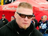 MMA fighter Brock Lesnar walks in the garage area during practice for the Daytona 500 at Daytona International Speedway on February 13, 2010