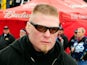 MMA fighter Brock Lesnar walks in the garage area during practice for the Daytona 500 at Daytona International Speedway on February 13, 2010