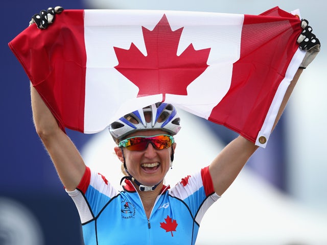 Catharine Pendrel of Canada celebrates winning gold in the Women's Cross-country Mountain Biking at Cathkin Braes Mountain Bike Trails during day six of the Glasgow 2014 Commonwealth Games on July 29, 2014