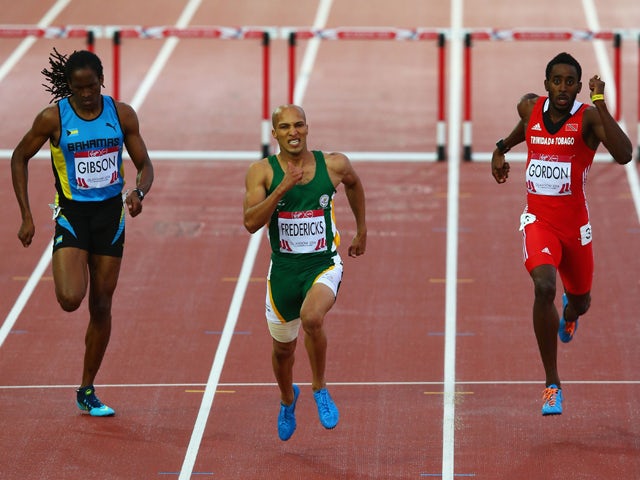 Cornel Fredericks of South Africa crosses the line ahead to win gold ahead of Jeffery Gibson of Bahamas and Jehue Gordon of Trinidad and Tobago in the Men's 400 metres hurdles final at Hampden Park during day eight of the Glasgow 2014 Commonwealth Games o