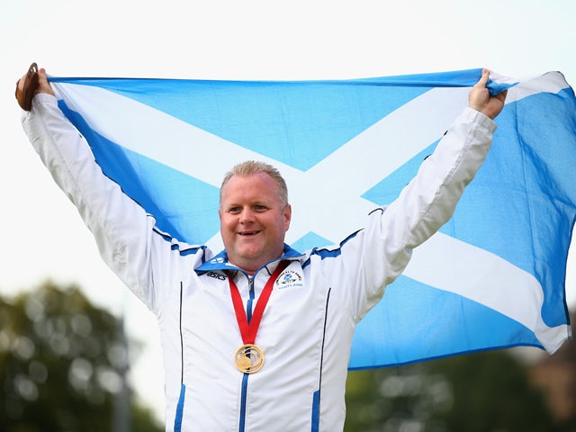 Darren Burnett of Scotland celebrates with his medal after winning the Gold Medal in the Men's Singles Final against Ryan Bester of Canada at Kelvingrove Lawn Bowls Centre during day nine of the Glasgow 2014 Commonwealth Games on August 1, 2014