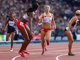 England's Emily Diamond passes the baton to teammate Shana Cox during the women's 4x400m relay heat on August 1, 2014