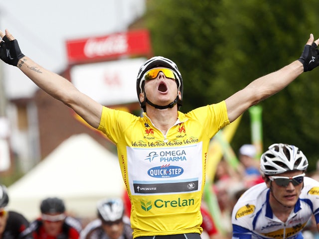 Belgium's Gianni Meersman of Omega Pharma-Quick Step team, wearing the leader's yellow leader, celebrates as he crosses the finishline to win the fifth and last stage of the Tour De Wallonie cycling race in Ans on July 30, 2014