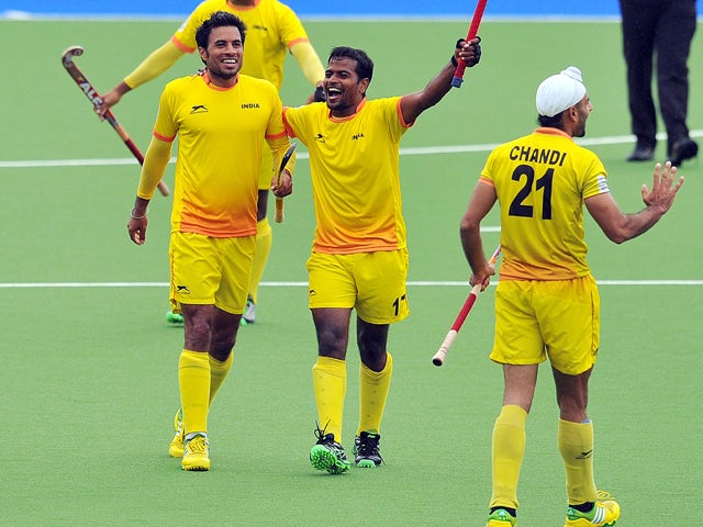 India's Gurbaj Singh and Danish Mujtaba celebrate winning their men's semi-final field hockey match between New Zealand and India at the Glasgow National Hockey Centre during the 2014 Commonwealth Games in Glasgow, Scotland, on August 2, 2014