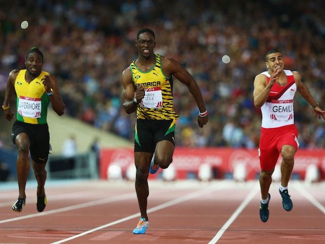 Kemar Bailey-Cole of Jamaica crosses the finish line of the men's 100m ahead of England's Adam Gemili on July 28, 2014