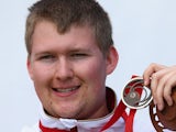 Kristian Callaghan of England holds his Silver medal after the 25m Rapid Fire Pistol Shooting event at Barry Buddon Shooting Centre during day six of the Glasgow 2014 Commonwealth Games on July 29, 2014