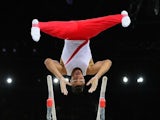 Louis Smith of England celebrates competes on the parallel bars during the Commonwealth Games men's artistic gymnastics team final at Glasgow's SSE Hydro on July 29, 2014