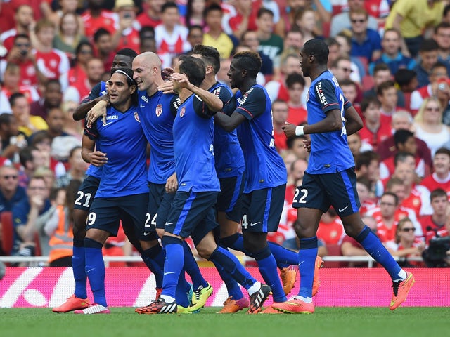 Radamel Falcao of Monaco celebrates scoring the first goal with team mates during the Emirates Cup match between Arsenal and AS Monaco at the Emirates Stadium on August 3, 2014