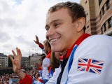 Britain's Paralympic swimming gold medalist Ollie Hynd waves during a parade celebrating Britain's athletes who competed in the London 2012 Olympic and Paralympic Games on September 10, 2012