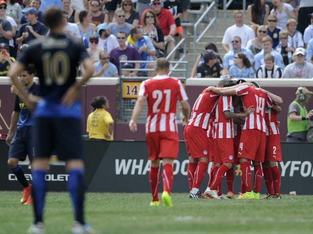 Edin Dzeko #10 of Manchester City looks on as Olympiacos celebrates a goal during the first half of the International Champions Cup match on August 2, 2014