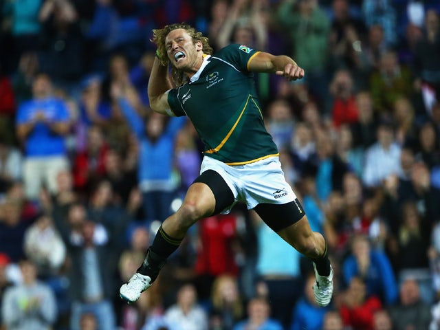 Werner Kok of South Africa jumps in the air to celebrate their win over New Zealand during the final match between South Africa and New Zealand at Ibrox Stadium during day four of the Glasgow 2014 Commonwealth Games on July 27, 2014