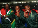 South African players Seabelo Senatla, Cecil Africa and Branco du Preez celebrate after win after the final match between South Africa and New Zealand at Ibrox Stadium during day four of the Glasgow 2014 Commonwealth Games on July 27, 2014