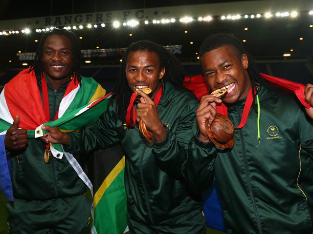 South African players Seabelo Senatla, Cecil Africa and Branco du Preez celebrate after win after the final match between South Africa and New Zealand at Ibrox Stadium during day four of the Glasgow 2014 Commonwealth Games on July 27, 2014