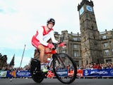 Steve Cummings of England goes past The Tolbooth during the Men's individual time trial during day eight of the Glasgow 2014 Commonwealth Games on July 31, 2014