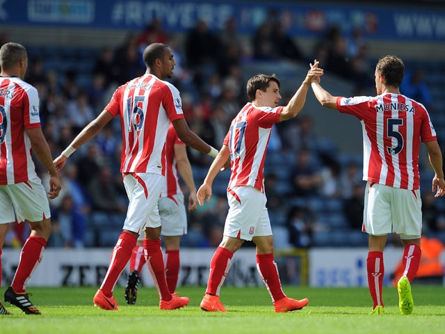 Bojan Krkic of Stoke City is congratulated by team-mate Marc Muniesa after scoring the equaliser during the pre season friendly match between Blackburn Rovers and Stoke City at Ewood Park on August 03, 2014