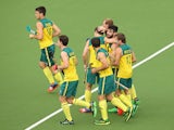 Trent Mitton of Australia celebrates with team mates after scoring during the Men's preliminaries match between South Africa and Australia at Glasgow National Hockey Centre during day five of the Glasgow 2014 Commonwealth Games on July 28, 2014