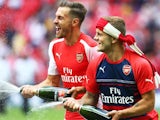 Arsenal's Aaron Ramsey and Jack Wilshere spray their teammates after winning the Community Shield on August 10, 2014