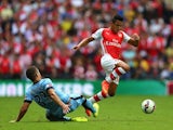 Arsenal's Alexis Sanchez leaps over Man City's Matija Nastasic during the Community Shield on August 10, 2014