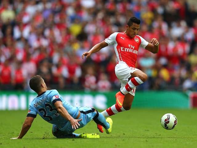Arsenal's Alexis Sanchez leaps over Man City's Matija Nastasic during the Community Shield on August 10, 2014