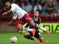 Aston Villa player Fabian Delph is challenged by Billy Clifford of Walsall during the Pre-Season Friendly between Walsall v Aston Villa at Banks' Stadium on August 5, 2014